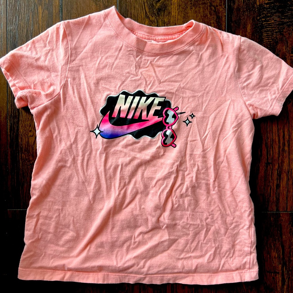 The Nike Tee peach color girl size Medium